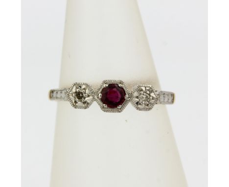 An 18ct yellow and white gold ring set with and round cut ruby and diamonds, (J)