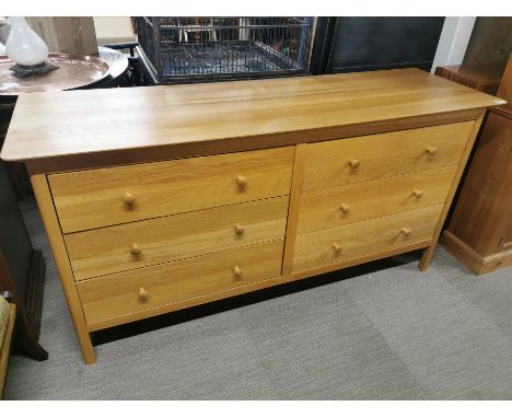 A light oak sideboard/ double chest of drawers with six drawers, 165 x 85 x 52cm.