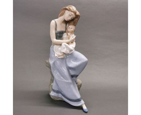 A large Nao figure of a mother and child with box, H. 38cm.