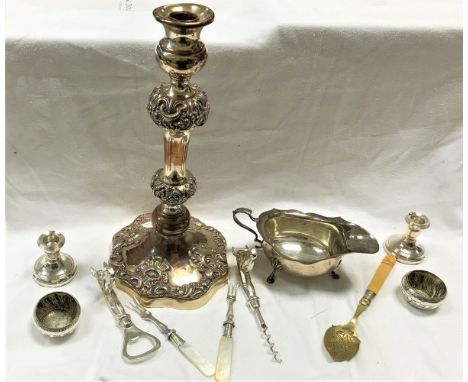 A silver sauceboat, two small silver candle holders, assorted silver and silver plated spoons, a single large silver on coppe