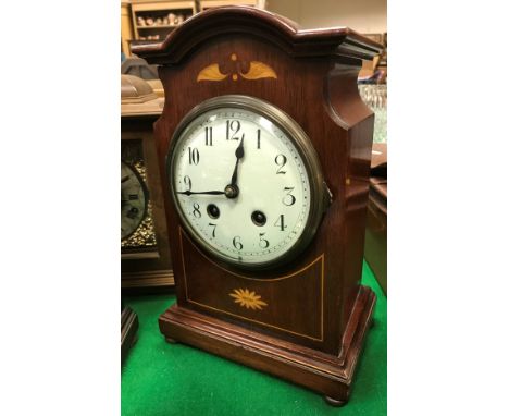 A circa 1900 Continental mahogany and inlaid cased mantel clock, the eight day movement with circular enamelled dial and Arab