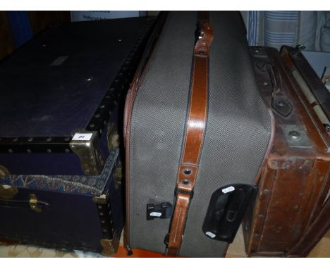 A modern trunk containing various scatter cushions, together with a suitcase of scatter cushions