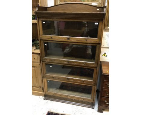 A "The Lebus" bookcase, the glass fronted four section bookcase with leaflet for Gunn sectional bookcase retailed by William 