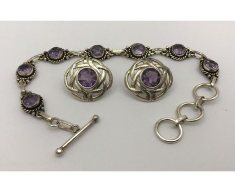 A modern silver and amethyst bracelet and earrings set