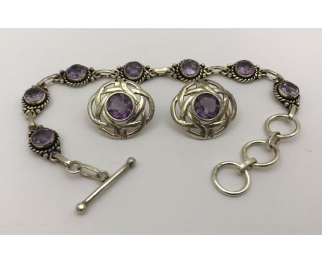 A modern silver and amethyst bracelet and earrings set