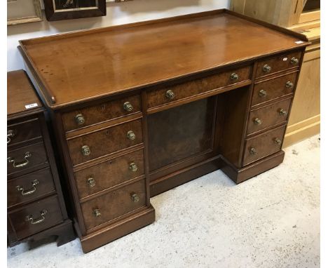 A Victorian burr walnut veneered kneehole desk by Morison &amp; Co of Edinburgh (central drawer stamped) with gallery top ove