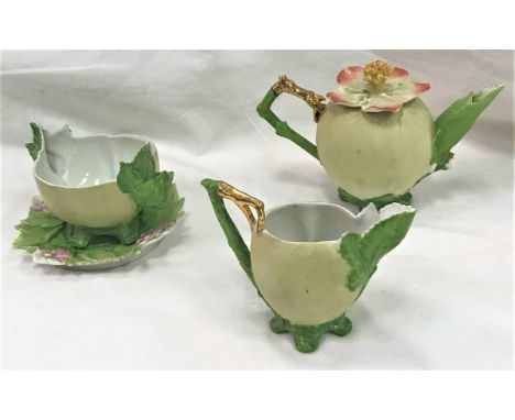 A circa 1900 Japanese biscuit fired "Peach" part tea set comprising teapot, sugar bowl, cream jug and saucer or stand (design