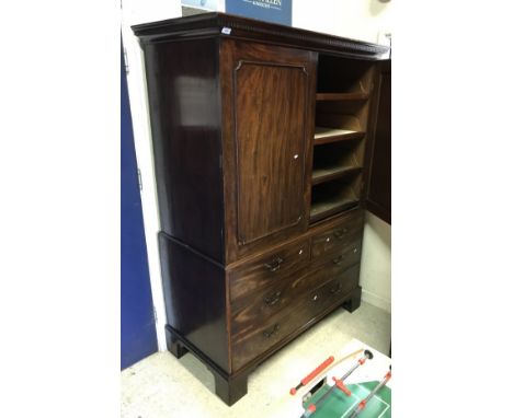 A Regency mahogany linen press, the upper section with two doors enclosing four linen shelves over two short and two long dra