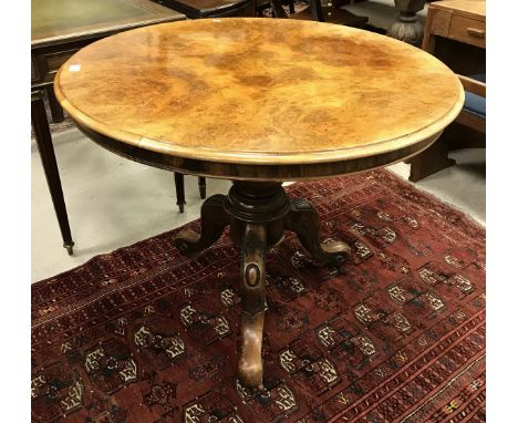 A Victorian walnut centre table, the burr quartered top with moulded edge, raised on a turned centre pedestal to tripod base