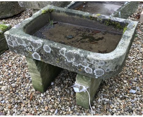 A natural stone trough with single rounded corner