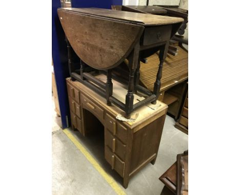 A 19th Century oak oval gate-leg drop-leaf dining table with single end drawer, together with a 1930's oak kneehole dressing 