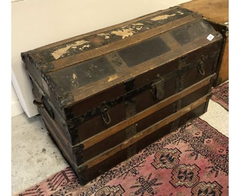 A Victorian dome top strapwork trunk bearing painted name "AM Bowler" and bearing various GWR Gloucester and other labels