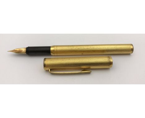 A yellow metal Dunhill fountain pen with engine turned decoration, inscribed "Dunhill Germany" to cap