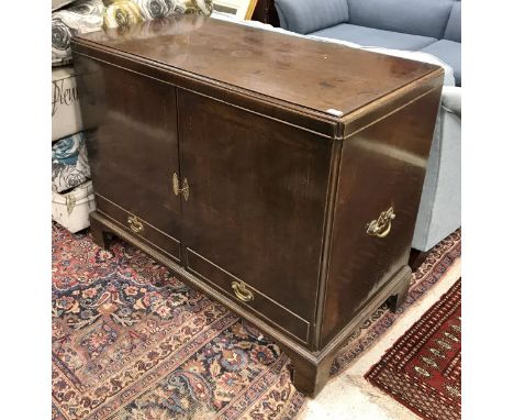 An 18th Century walnut press cupboard, the top with moulded edge over two drawers with dummy drawers enclosing adjustable she