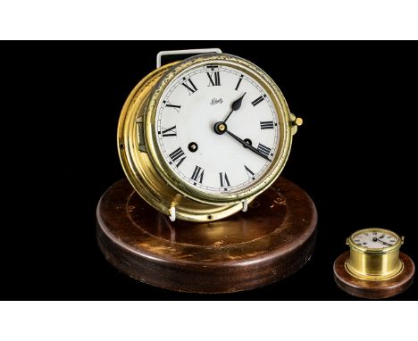 Original Brass Ships Clock, wind-up clock on wooden base, lacking glass; 7 inches (17.5cms) in diameter; working at time of c