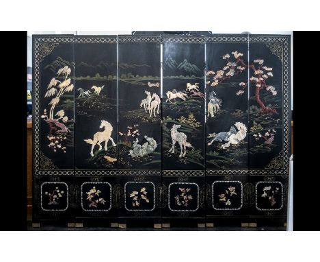 A Six Panel Chinese Lacquered and Hardstone Applied Screen depicting wild horses in landscape with cherry blossom trees and w