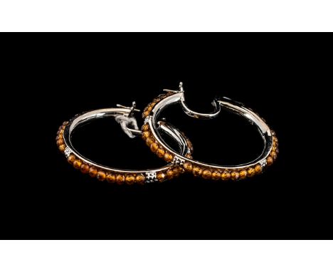 Hessonite Garnet Large Hoop Earrings, round, facetted, hessonite garnets totalling 7.5cts, set in a channel the full circle o