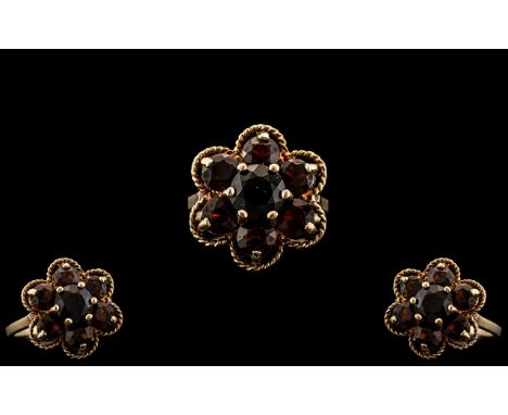 Ladies 9ct Gold Attractive Garnet Set Ring - Flower head Setting. Fully Hallmarked for 9.375. Ring Size M. Excellent Setting.