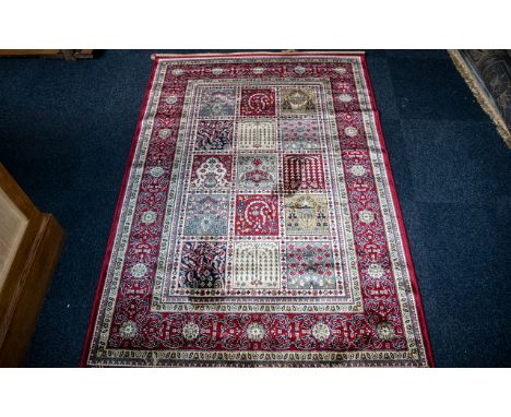 A Genuine Cashmere Red Ground Carpet/Rug. Persian panel design. As new condition. Measures 2.40 by 1.60 metres. 