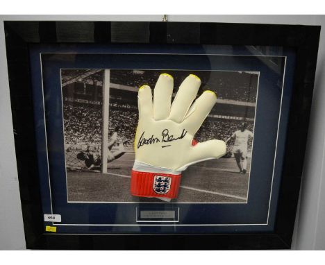 Goalkeepers glove, signed by Gordon Banks, mounted over black and white print of the player famously saving Pele's goal at th