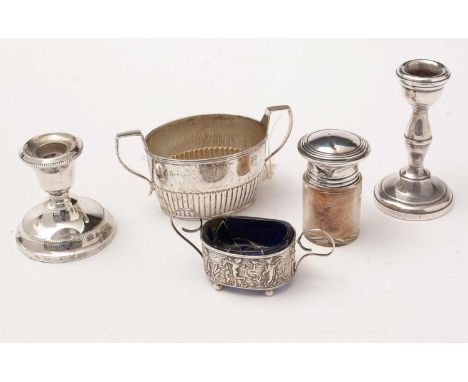 A collection of small silver: including; a silver-mounted glass smelling salts jar; a salt with figural decoration; a sugar b