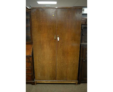 An early 20th Century oak two-door compactum by Verithing retailed by Alfred Bratt of Sunderland, the caddy top above a pair 