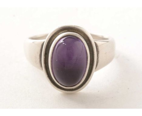 A Georg Jensen amethyst cabochon ring, set in white metal, marked '925 Denmark', size R 1/2, 7.1g gross.
