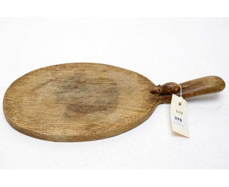 Robert 'Mouseman' Thompson carved oak cheeseboard, of oval form with carved mouse figure to handle, 38cms wide.