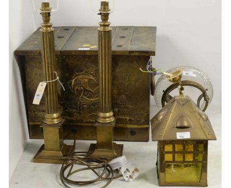 An early 20th Century brass coal box, of twin-handled trunk form, the front panel embossed with a shipping scene, 45cms wide;