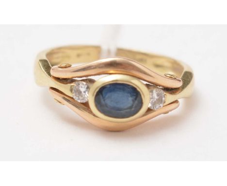 A modern diamond and sapphire three-stone ring, on a yellow metal shank, stamped 750, size K 1/2, 4.9g gross.