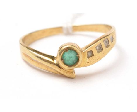 A modern emerald and diamond ring, on a yellow-metal shank, stamped 750, size R 1/2, 2.9g gross. 