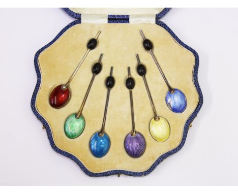 A cased set of hallmarked silver and enamel bean spoons