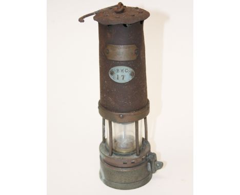 A miner's lamp. H29cm. Condition - rusty, glass appears free from damage.