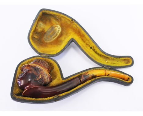 A carved meerschaum pipe with amber mouth piece. L18cm