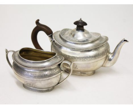 A Victorian silver teapot and sugar bowl. London 1876. Gross wt. 14oz. Condition - foot of teapot bent, finial cracked, no th