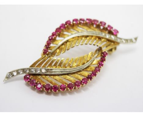 An 18ct gold diamond and ruby brooch. L5cm. Gross wt. 7.7g