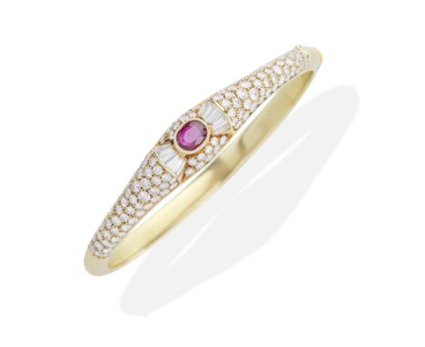 RETAILED BY GARRARD: RUBY AND DIAMOND BANGLE, CIRCA 1990Cushion-shaped ruby, brilliant and baguette-cut diamonds, mounted in 