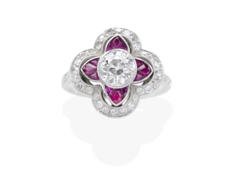 RUBY AND DIAMOND RING, CIRCA 1920The old brilliant-cut diamond, within an openwork quatrefoil surround of calibré-cut rubies 