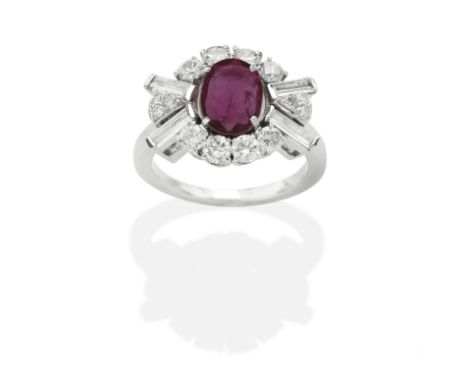 RUBY AND DIAMOND RINGThe cushion-shaped ruby, within a brilliant and baguette-cut diamond surround, ruby approx. 1.45cts, dia