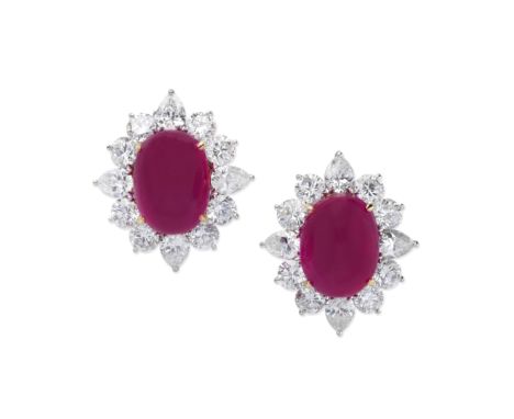 RUBY AND DIAMOND EARCLIPSThe sugarloaf cabochon rubies, weighing 9.88 and 10.61 carats, within a brilliant-cut and pear-shape
