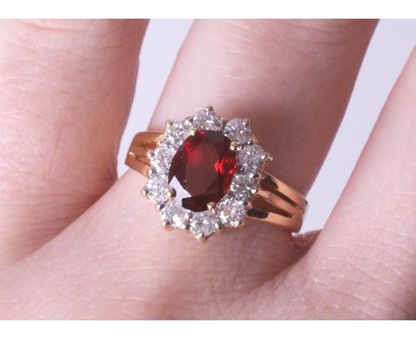 An 18ct diamond and garnet cluster ring, size M.