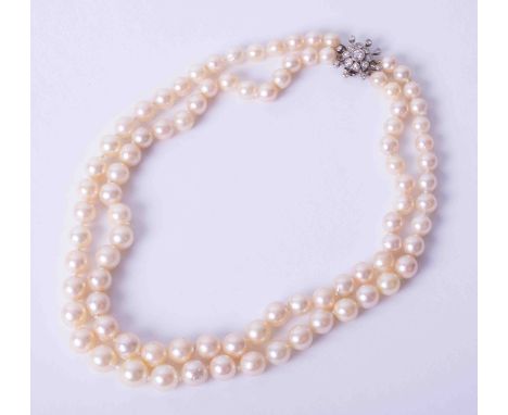 A double row pearl necklace with diamond set clasp.
