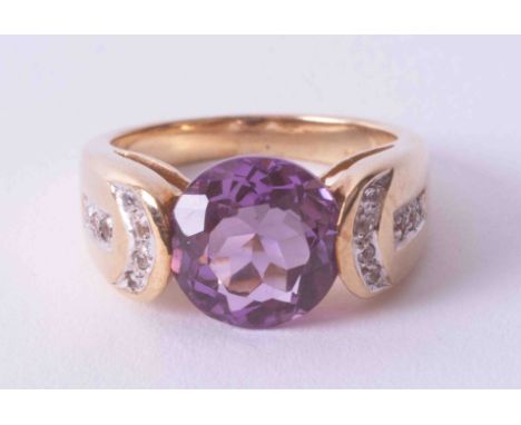 A modern 9ct yellow gold ring with tension set amethyst and diamond detail on the shoulders, finger size N.