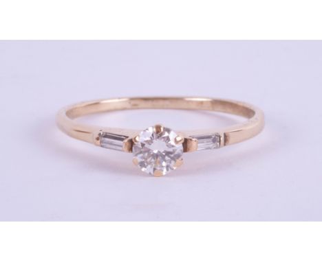 An 18ct yellow gold diamond ring set with further diamonds to the shoulders, approx. 0.50ct, ring size R.