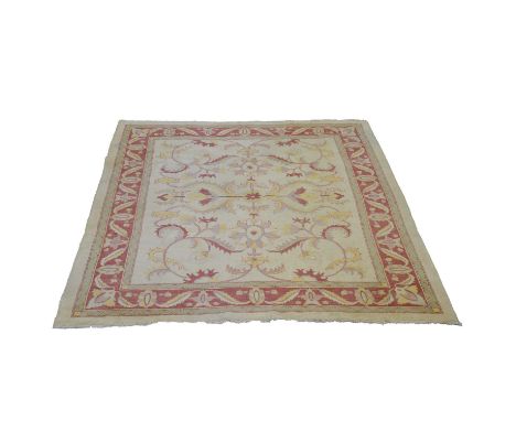 Zeigler style carpet, scrolling design on a pale ground, flower head and leaf border, 324x278cm.