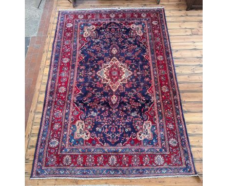 A Persian Mahal carpet, having a central medallion on a blue ground, within multiple borders, 318 x 215cm