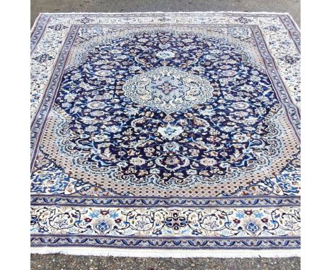 A Persian Naeem carpet, with all over foliate designs, on a pale ground, 388 x 286cmOverall condition looks to be complete, w