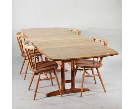 An Ercol light elm draw leaf dining table, with two additional leaves, 252cm overall, together with a set of four Ercol stick