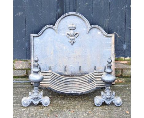 A cast iron fireback, decorated in relief with a fleur-de-lys, 66 x 72cm, together with a pair of fire dogs and a grate (4)