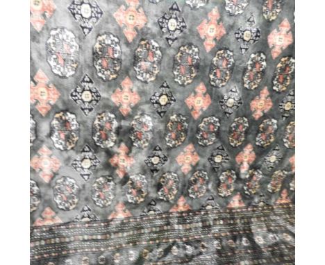 A large Persian carpet, with all over medallions, on a green ground, 381 x 287cm